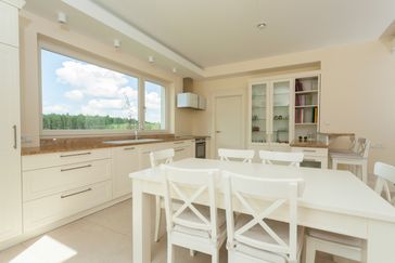 Bright contemporary kitchen with big white table